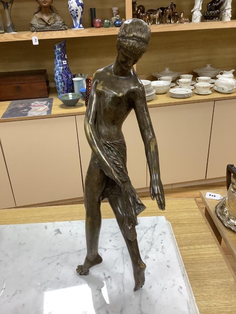 An Art Deco style bronze lady and a marble sphere, on marble base, length 76cm